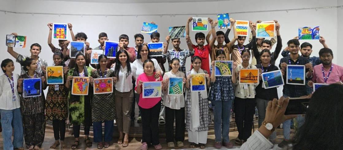 Students holding up paintings from a pre-festival workshop